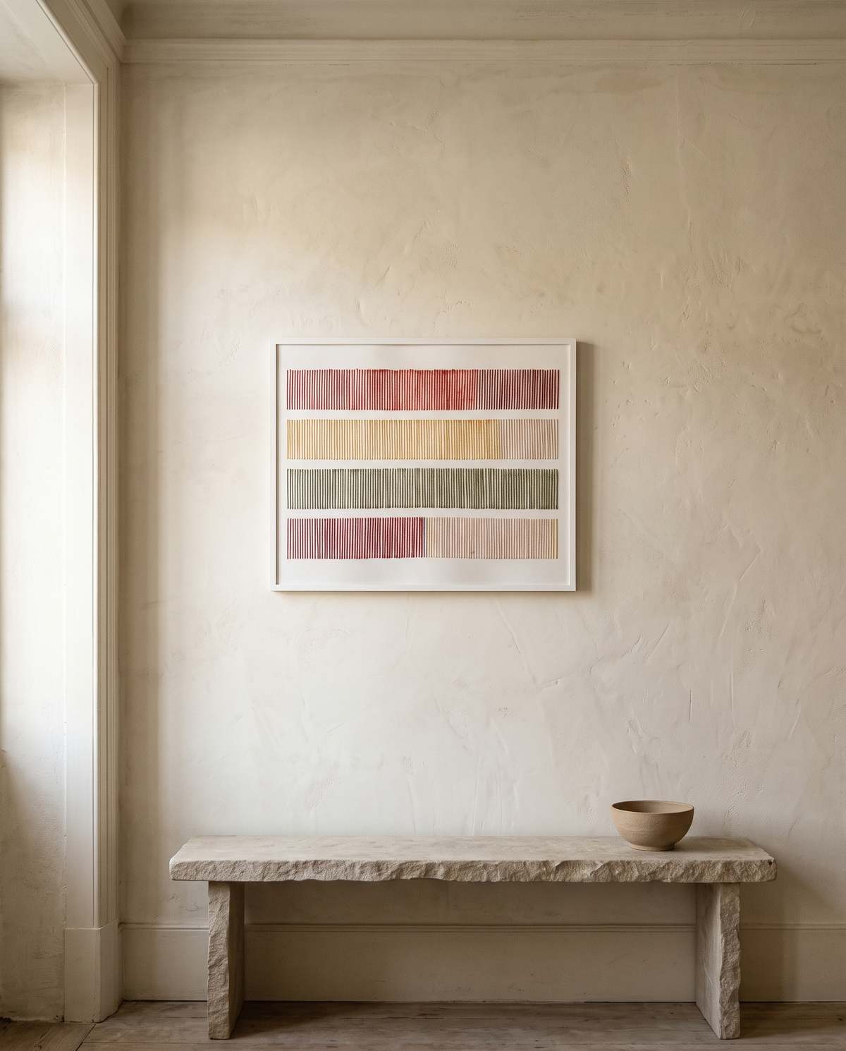Cadence, hand-embroidered textile wall art by Nyra Atelier, framed on a cream lime-plaster wall above a limestone bench