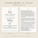 Hang tag of Mia by Nyra Atelier: decorative collectible for collectors aged 14+, not a toy; materials, care and maker details