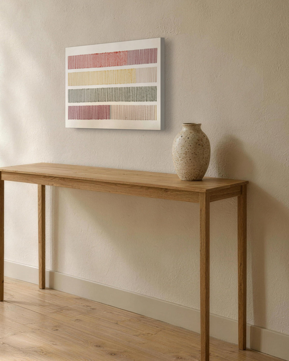 Cadence, hand-embroidered textile wall art on a stretched canvas without a frame, hung on a lime-plaster wall above a slim oak console with a stoneware vase in soft window light. AI setting: the room was created with AI; the piece is a real photograph.
