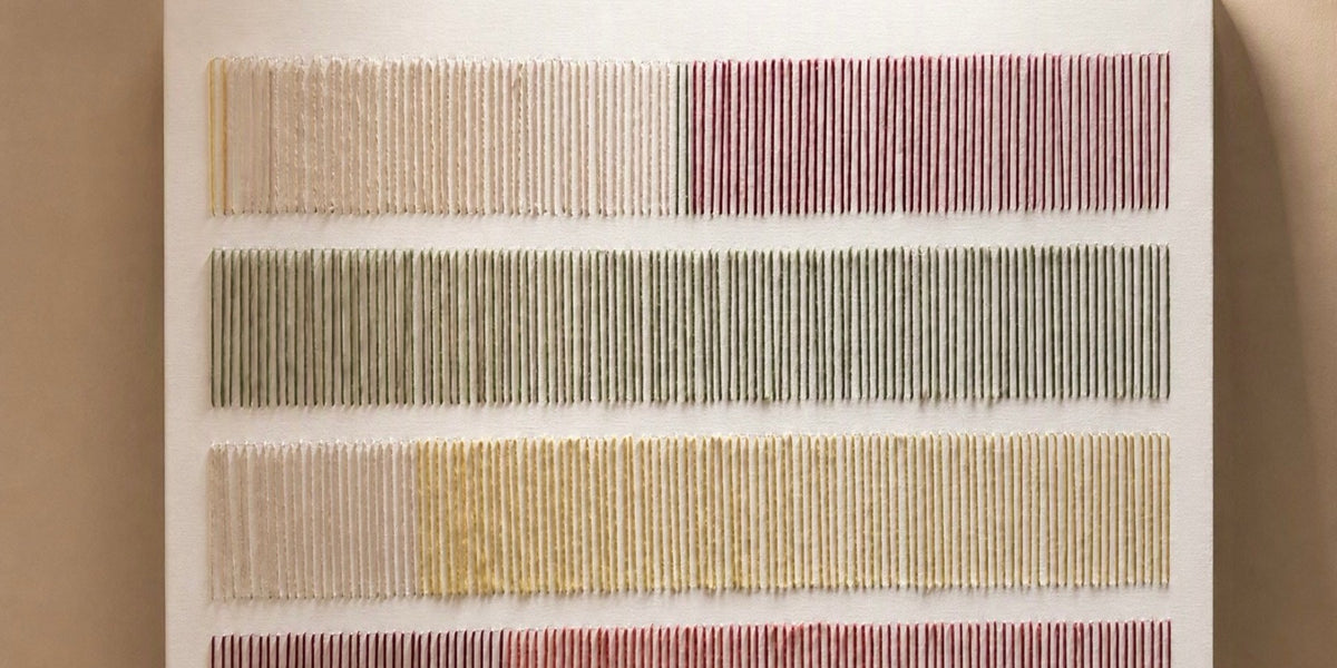 Close-up of Cadence, a hand-embroidered thread art canvas made by Nyra Atelier in Porto, with stitched stripes in blush, olive green and mustard