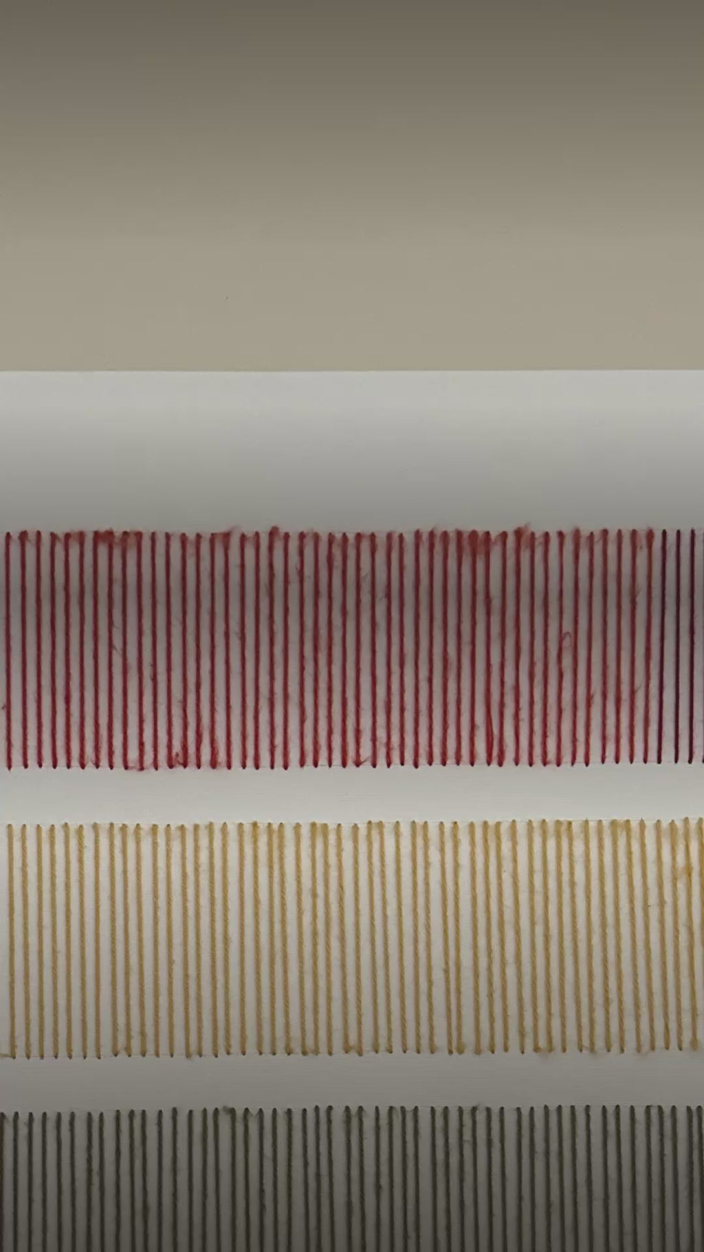 Video: close-up of the stitched wool rows on Cadence, in red and mustard