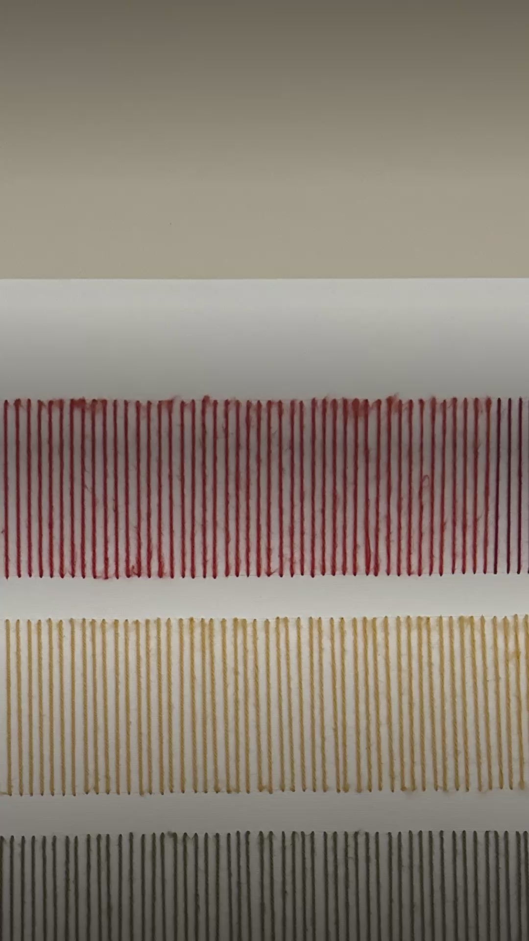 Video: close-up of the stitched wool rows on Cadence, in red and mustard