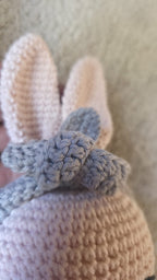 Close-up of Luna's cream ears and her removable grey crochet flower headband, made by hand in Porto