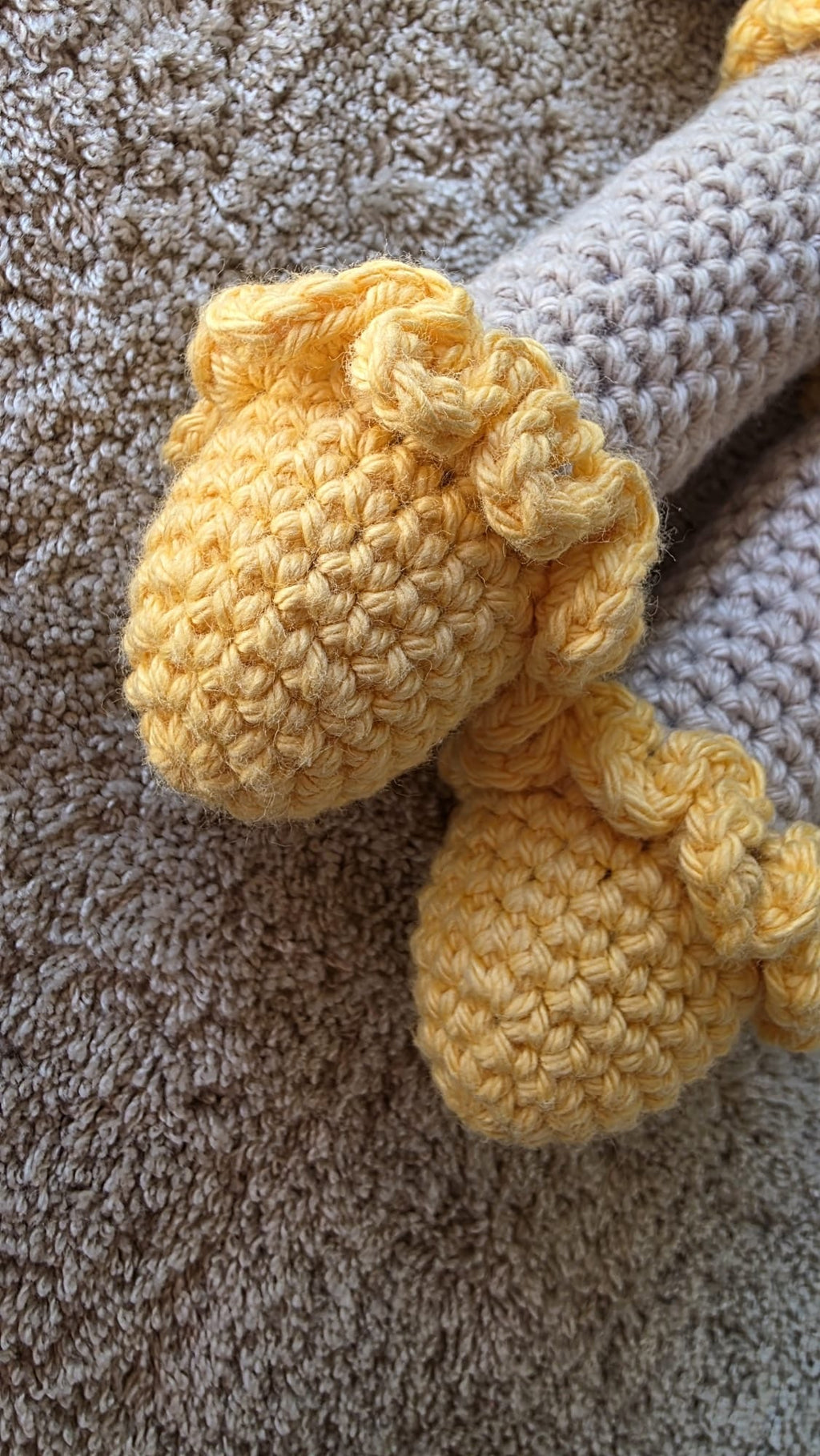 Close-up of Sol's removable yellow crochet shoes with ruffled cuffs, made by hand in Porto